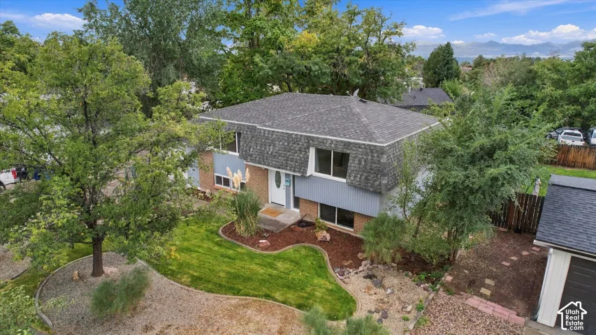 Two-story residence with a gambrel roof and light blue siding
