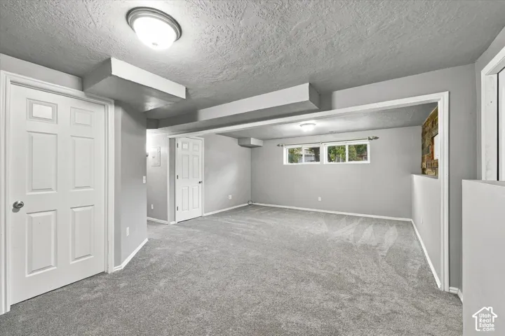 Carpeted flooring, recessed lighting, multiple windows, and paneled interior doors