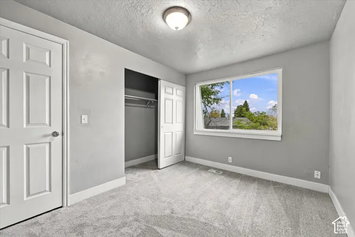 Textured walls complement soft gray carpeting and white trim