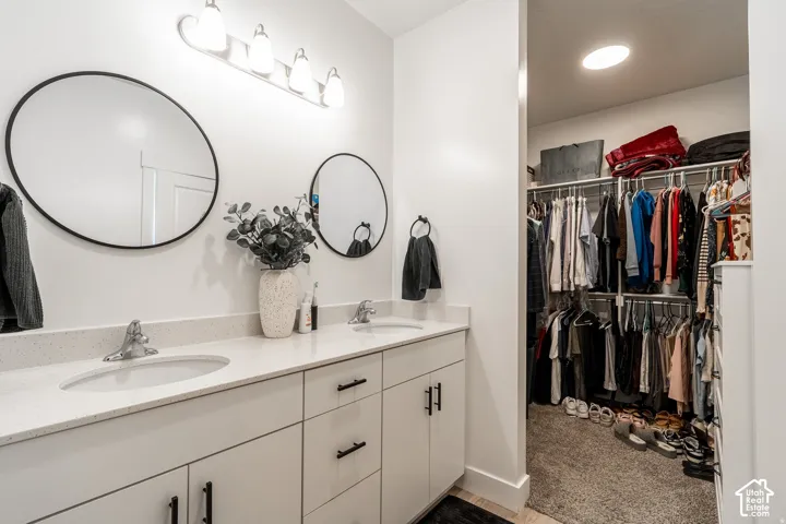 Dual-sink vanity with quartz countertop, matte black hardware, and polished chrome faucets