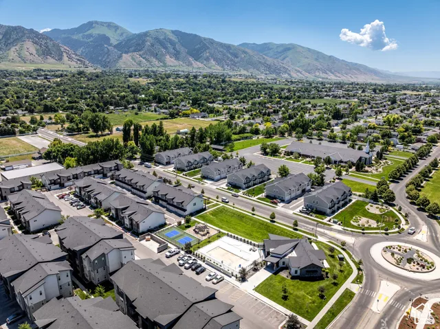 Aerial view of a planned residential community featuring contemporary two-story homes with modern architectural styling, manicured landscaping, and tree-lined streets