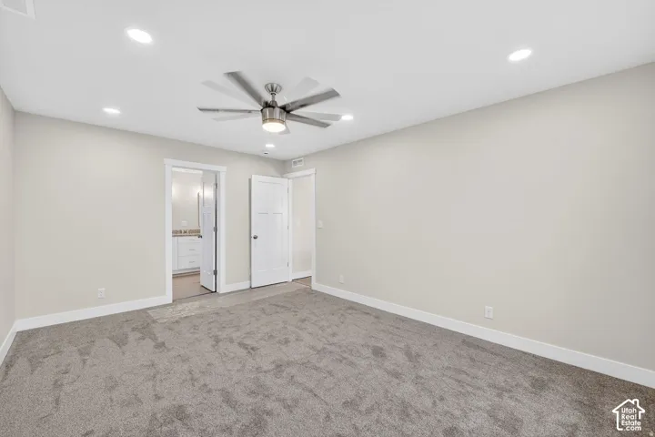 Recessed ceiling lighting, ceiling fan with integrated lighting, neutral wall paint, gray carpeting, and white trim