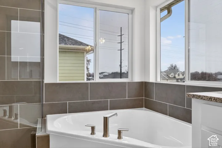 Corner soaking tub with brushed nickel fixtures