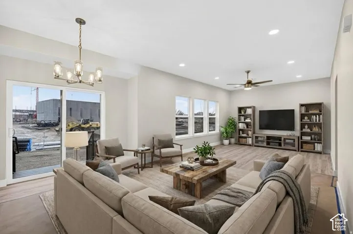 Expansive living space featuring wood-finish flooring, recessed lighting, and a ceiling fan