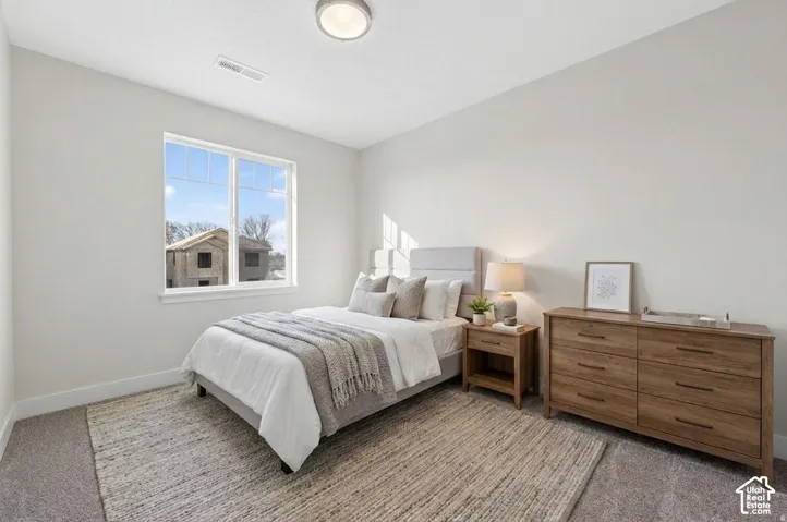 Carpeted flooring, white walls, and a large window
