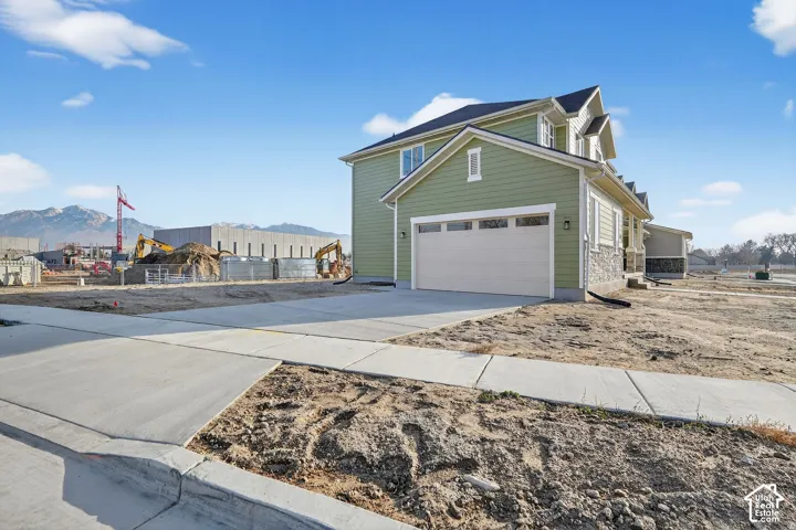 Two-story exterior with light green siding and stone accents