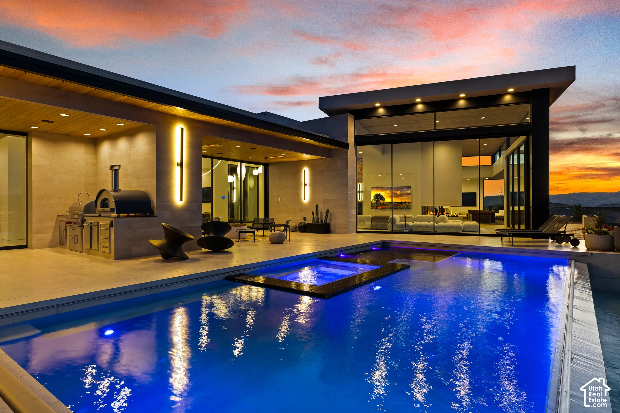 Modern exterior with a swimming pool, integrated spa, built-in outdoor kitchen, and floor-to-ceiling glass paneling