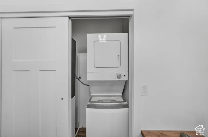 White sliding closet doors conceal a stackable washer and dryer unit