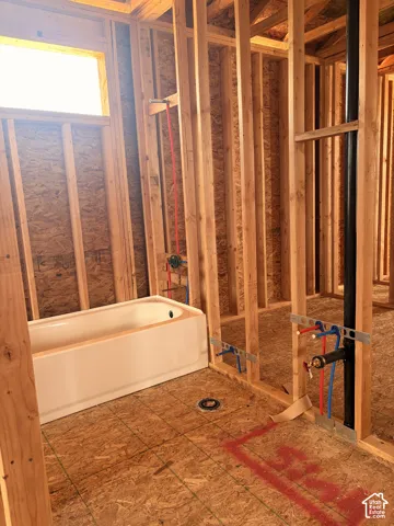 New construction framing with visible plumbing rough-ins