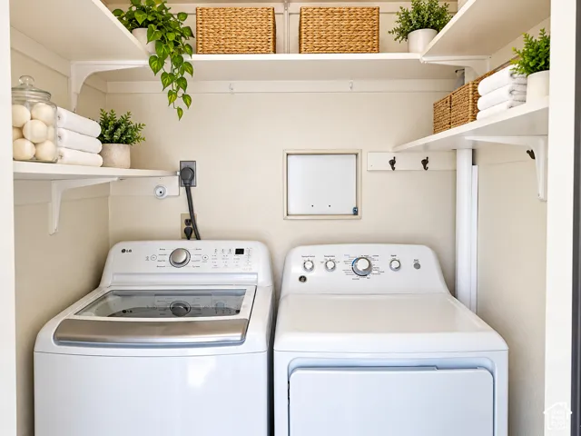 Laundry alcove featuring white, top-loading washer and dryer, stacked wall-mounted shelving, and integrated wall hooks