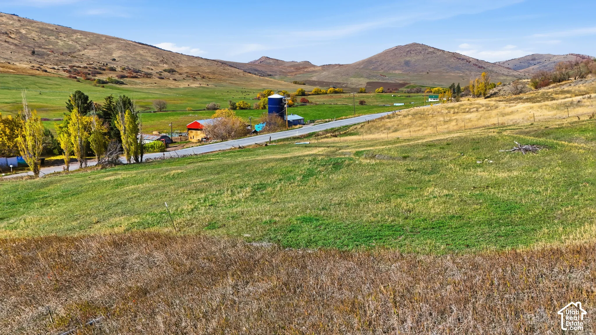 Expansive acreage featuring rolling terrain, natural vegetation, and prominent mountain backdrops