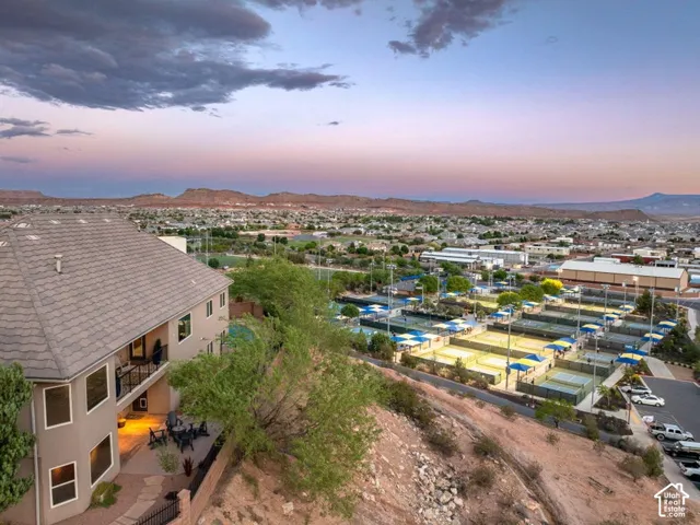 Two-story residence with a multi-level roofline and a lower-level patio