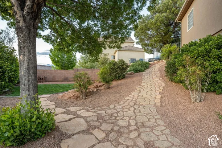 Stone pathway with gravel landscaping and mature trees