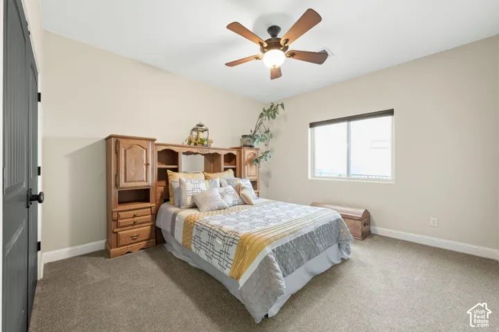 Recessed lighting with a ceiling fan, neutral wall paint, built-in wooden cabinetry, window with privacy blinds, and carpeted flooring