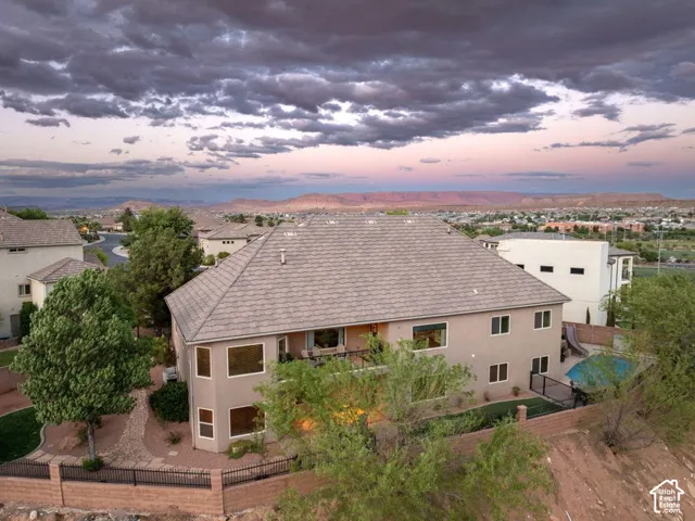 Multi-story stucco residence with a multi-gabled roof and multiple windows