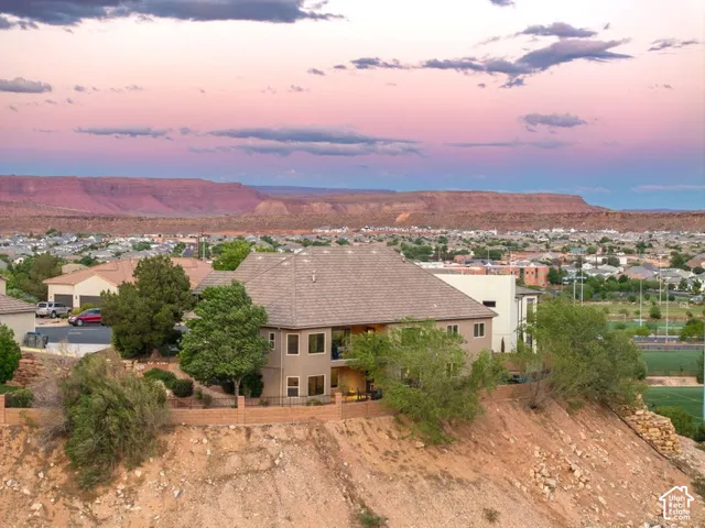 Property featuring a hip roof, multi-story design, and an elevated position