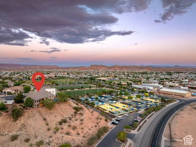 Elevated property with a multi-story structure, terraced landscaping, and desert flora