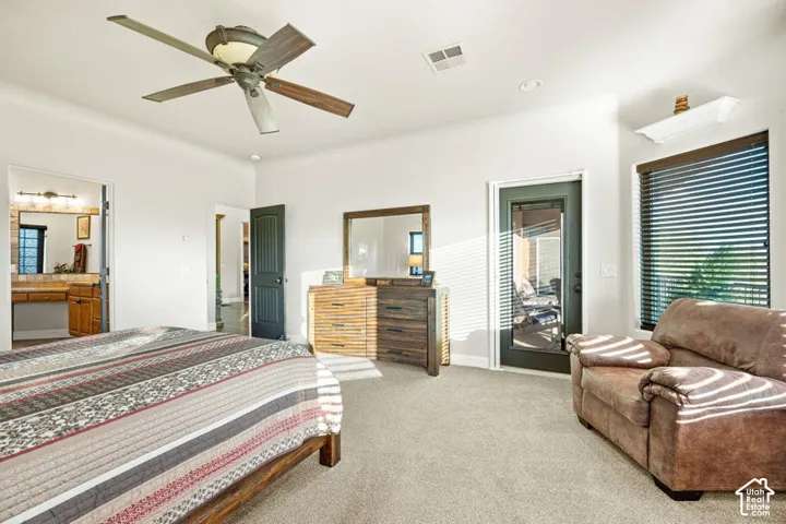 Carpeted bedroom with a ceiling fan, recessed lighting, and a glass-paneled door