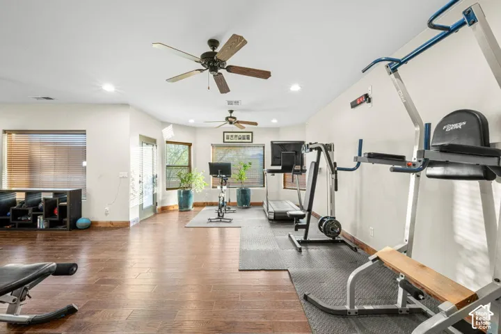 Wood-finish flooring, recessed lighting, and multiple ceiling fans