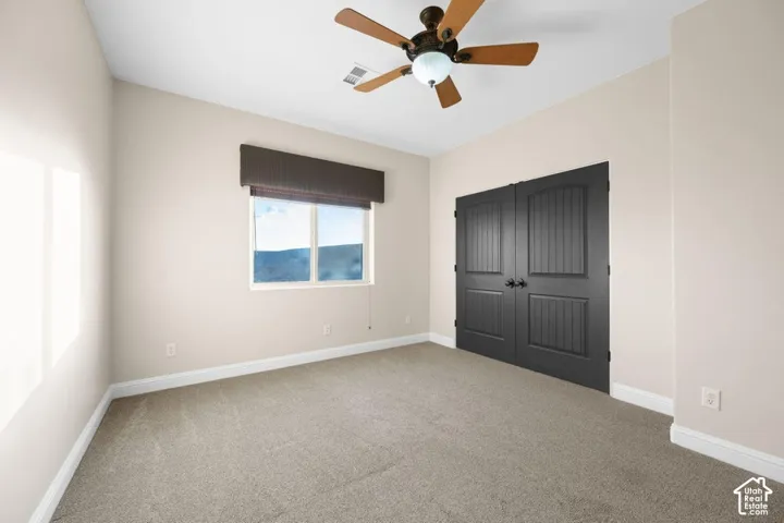 Light-toned walls complement plush carpeting