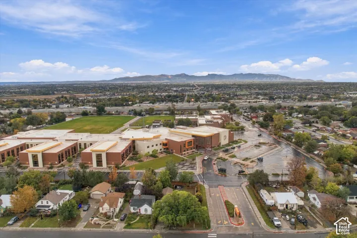 Aerial perspective featuring residential lots and large-scale structures, set against a backdrop of prominent mountain ranges