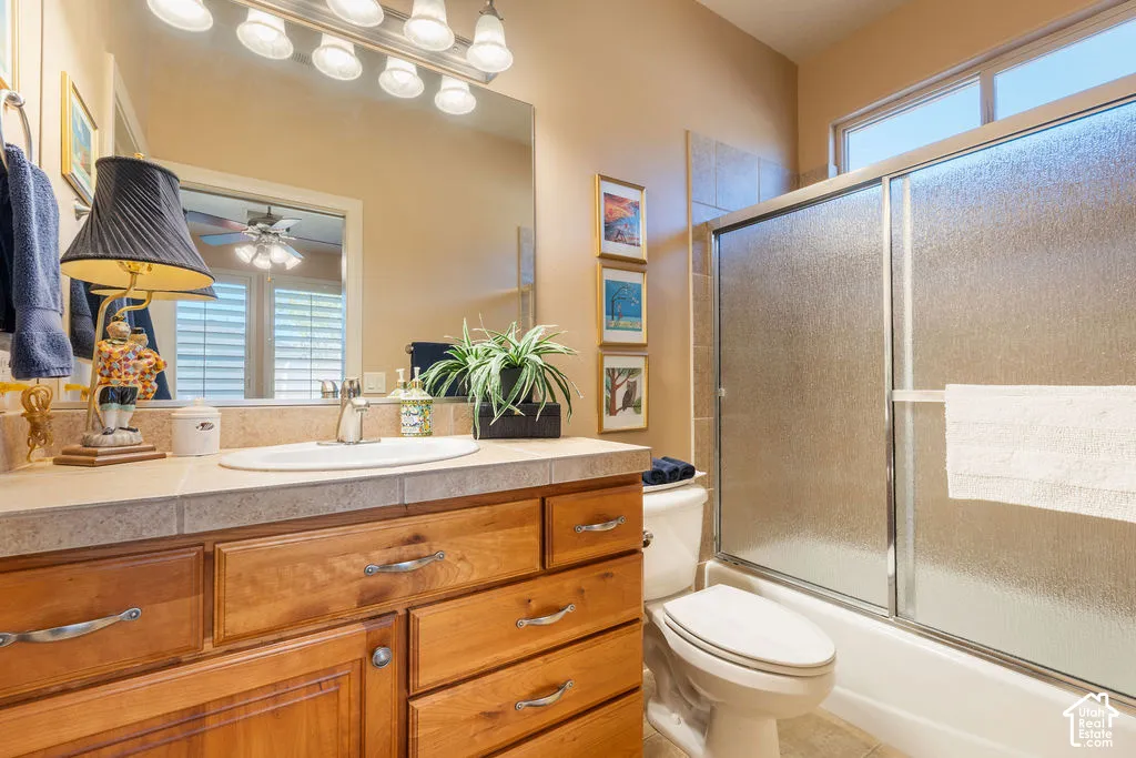 Wood-finish vanity with tile countertop, undermount sink, and polished chrome faucet