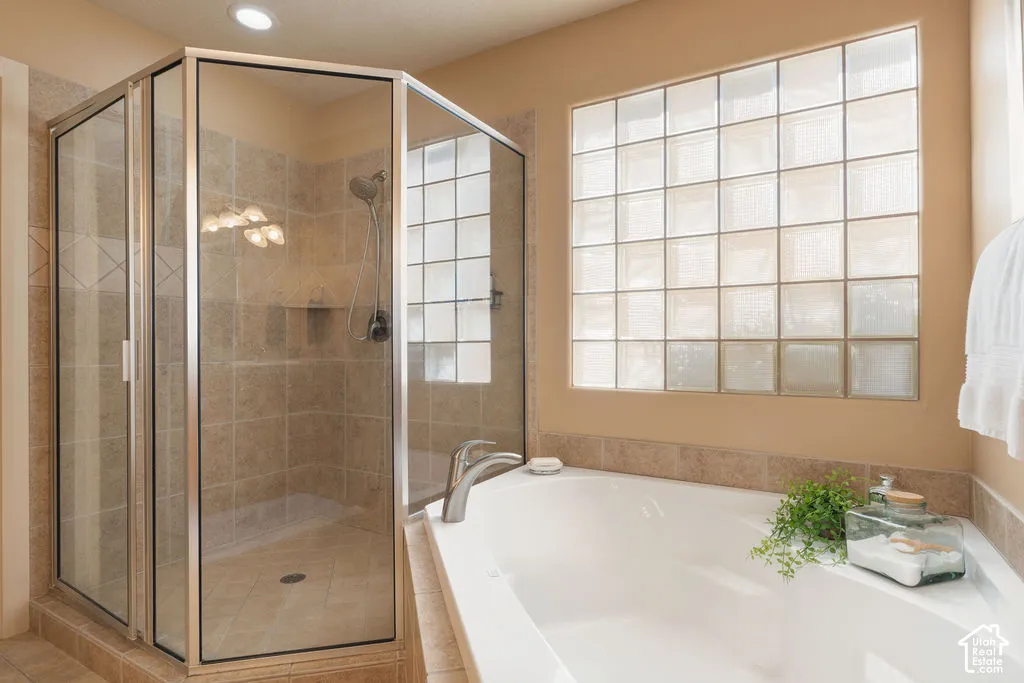 Glass-enclosed shower with tiled walls and a built-in niche