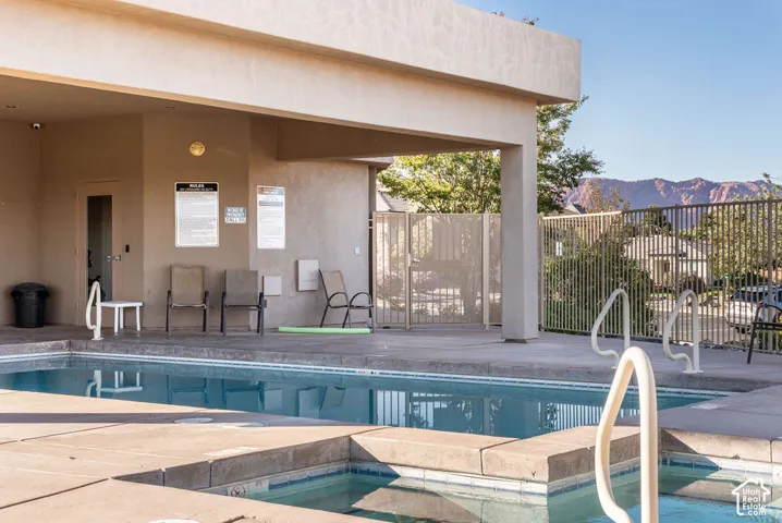 Outdoor swimming pool with integrated spa and concrete decking