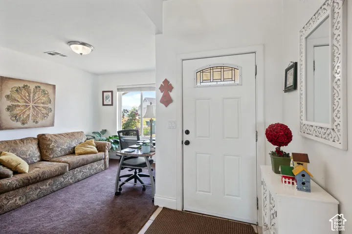 White paneled entry door with an arched window insert