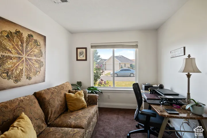 Neutral wall finishes, recessed lighting, and a large window providing natural light