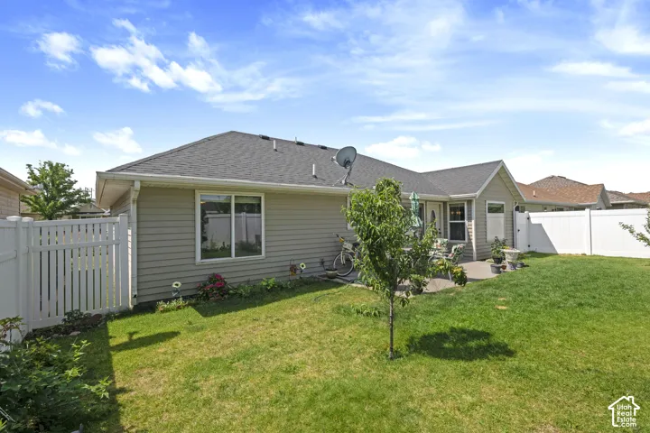 Charming single-story home with gray fiber cement siding and a dark asphalt roof