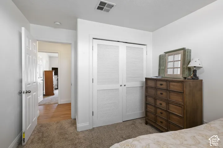 Louvered bi-fold closet doors, white trim, and neutral wall color