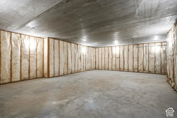 Concrete flooring, insulated wall framing, concrete ceiling, recessed lighting, exposed piping