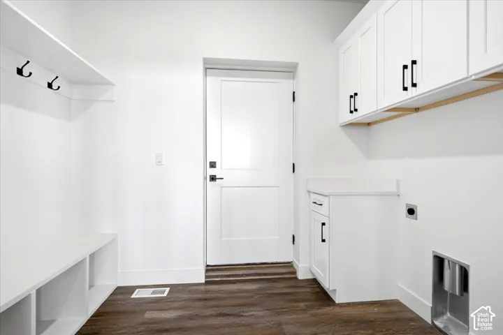Mudroom with wood-finish flooring, white built-in cabinetry, and integrated coat hooks