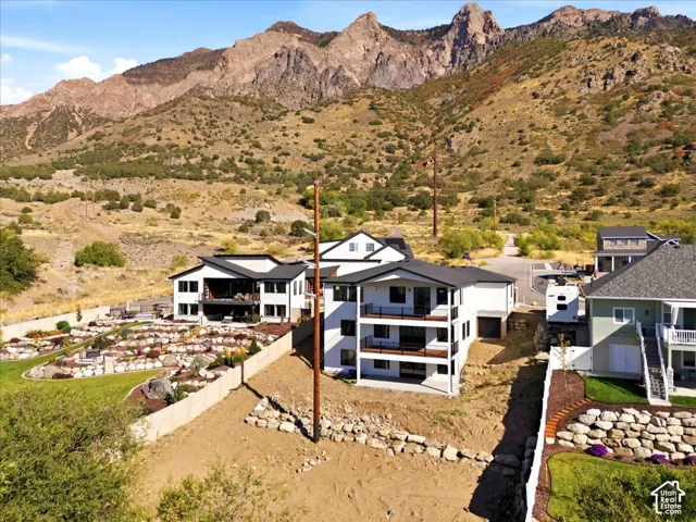 Contemporary multi-level residence with multiple balconies and a dark-pitched roof