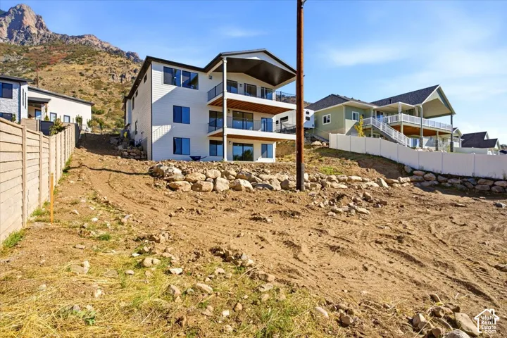 Three-story residence with multiple balconies and exterior siding