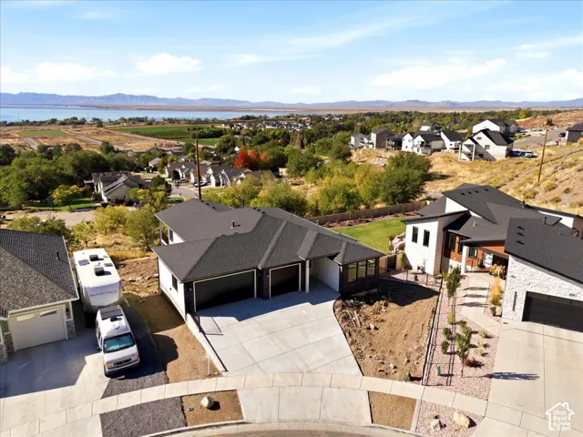 Contemporary-style residence with a dark shingle roof and a two-car garage