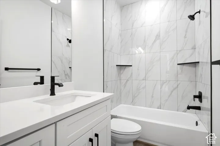 White rectangular vanity with an integrated sink and matte black faucet