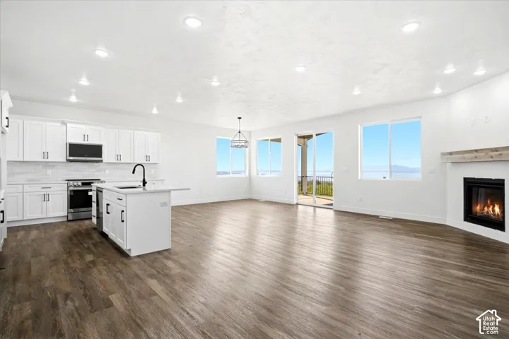 Open-concept living area with wood-finish flooring