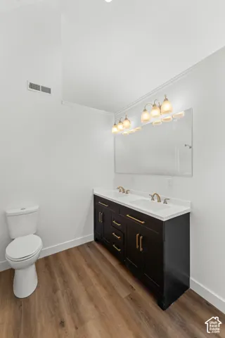Dual vanity with white countertop, dark wood-finish cabinetry, and gold-tone hardware