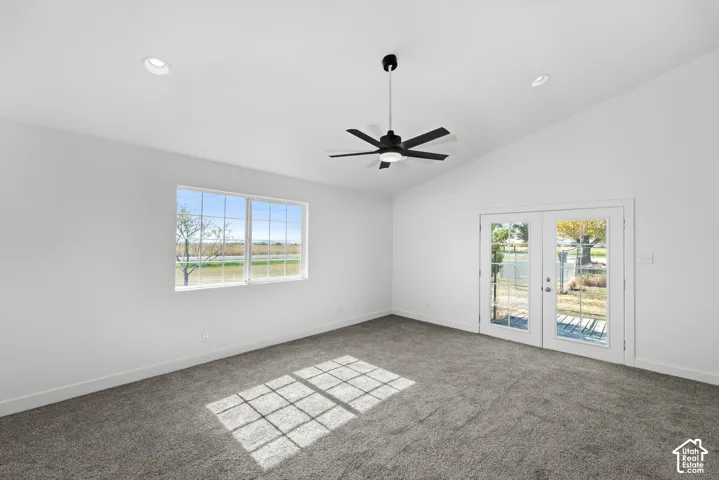 Vaulted ceiling with a contemporary ceiling fan, recessed lighting, and soft gray carpeting