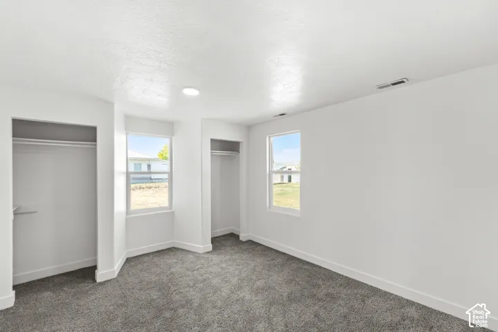 Two open closets with shelving and hanging rods