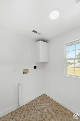 Recessed ceiling lighting, built-in wall cabinet, wire shelving, and patterned flooring