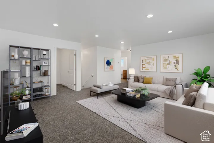 Recessed lighting, light-colored walls, and neutral-toned carpeting create a bright interior