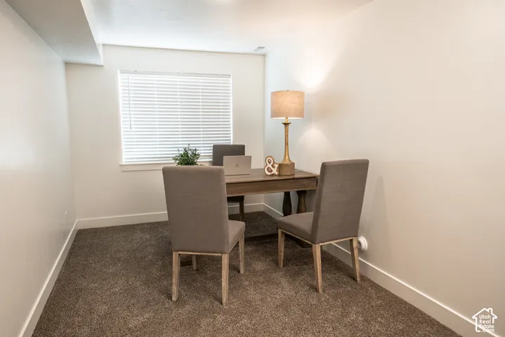 Carpeted flooring, white walls, and a window with blinds