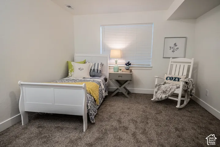 Light-toned walls, neutral carpet, and a window with blinds
