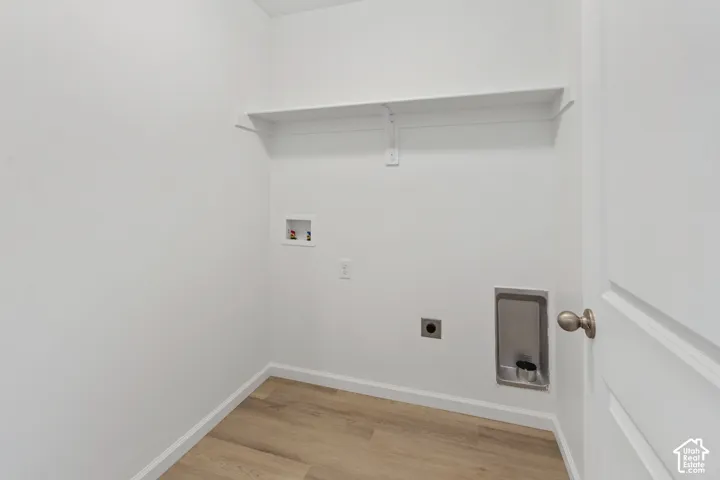Wood-finish flooring with white walls and a built-in shelf