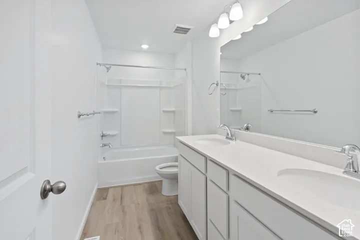 Dual vanity with white cabinetry, light-toned countertop, and undermount sinks