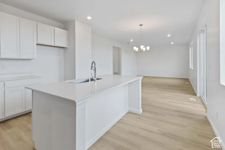 Kitchen island with a stainless steel sink and gooseneck faucet