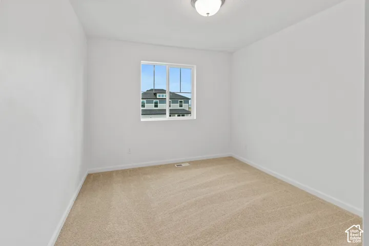 Recessed window with multi-pane glazing, neutral carpeting, and a flush-mount ceiling light